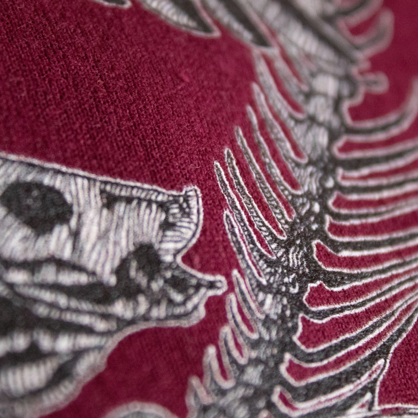 Close-up on black and white, tattoo inspired, gothic, witchy, pagan art on clothing piece. Birds & Bones collection features nature and death inspired artwork on t-shirts and sweathirts.