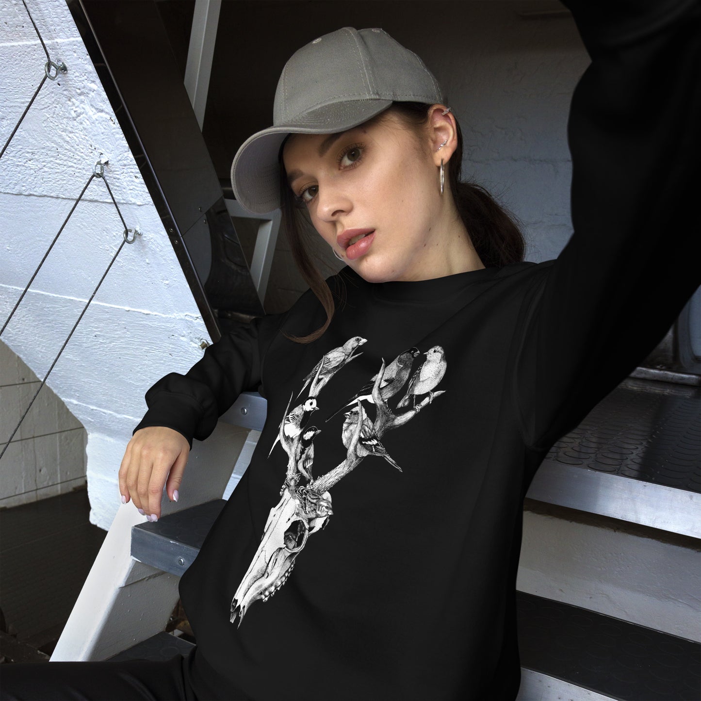 Model wearing sweatshirt with black and white, tattoo inspired, gothic, witchy, pagan art.